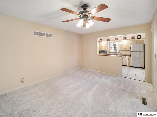 interior space with ceiling fan and light carpet