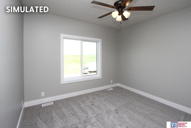 unfurnished room with ceiling fan and carpet