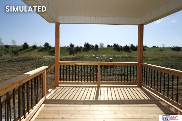 wooden deck featuring a rural view