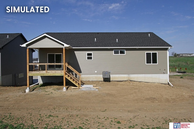 rear view of house with a wooden deck and cooling unit