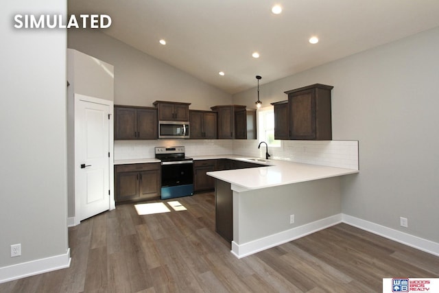 kitchen featuring kitchen peninsula, appliances with stainless steel finishes, tasteful backsplash, sink, and pendant lighting