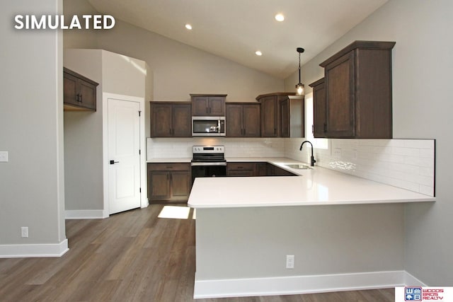 kitchen with sink, stainless steel appliances, tasteful backsplash, kitchen peninsula, and pendant lighting