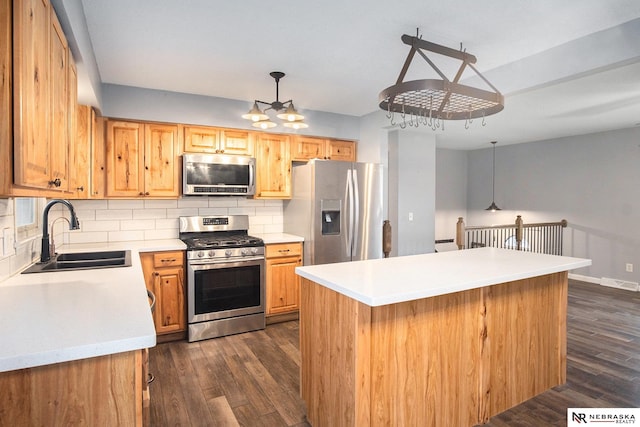 kitchen featuring sink, hanging light fixtures, backsplash, a chandelier, and appliances with stainless steel finishes