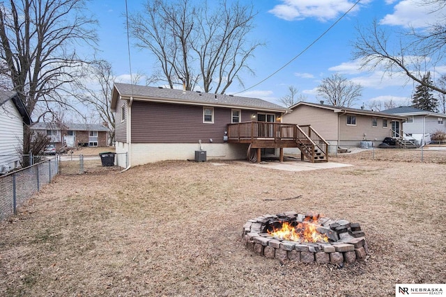 back of house with a deck, an outdoor fire pit, and central air condition unit