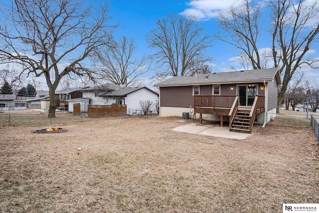 rear view of property featuring a lawn, central air condition unit, and a deck