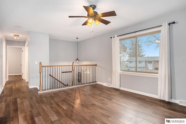 empty room featuring dark hardwood / wood-style floors and ceiling fan