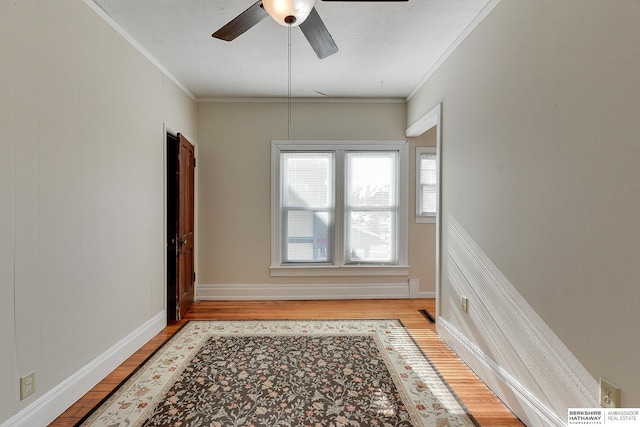 unfurnished room with ceiling fan, ornamental molding, and light wood-type flooring