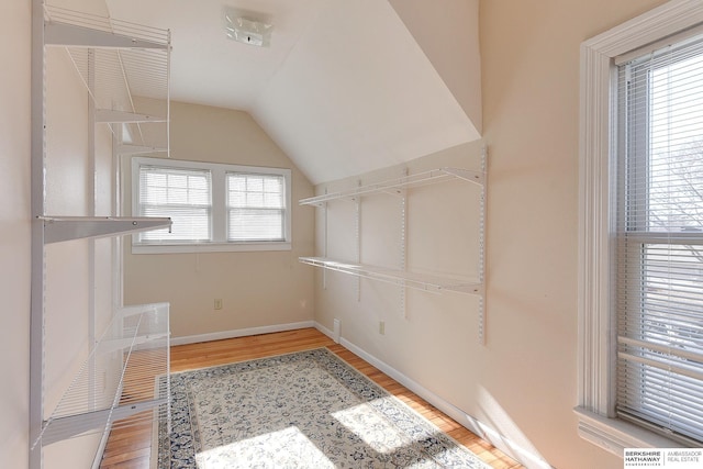 spacious closet featuring hardwood / wood-style floors and lofted ceiling