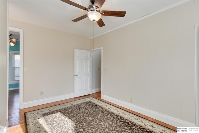 unfurnished room featuring crown molding, hardwood / wood-style floors, and ceiling fan