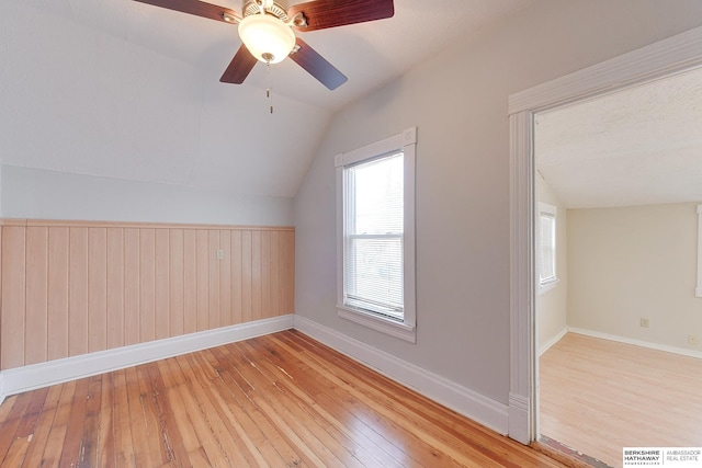 bonus room featuring light wood-type flooring, ceiling fan, and lofted ceiling