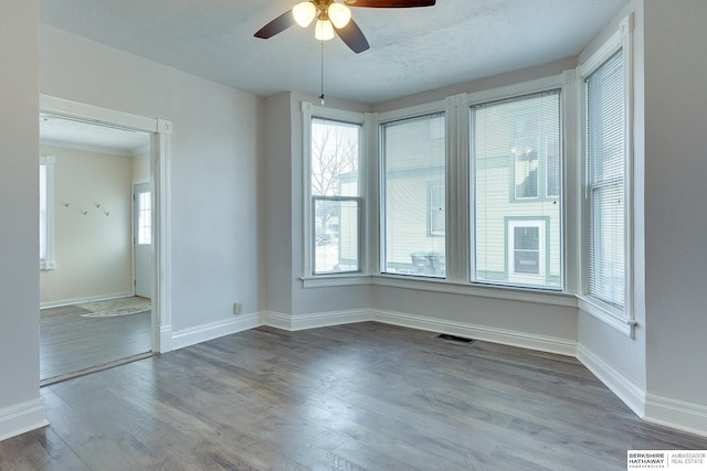 unfurnished room featuring hardwood / wood-style flooring and ceiling fan