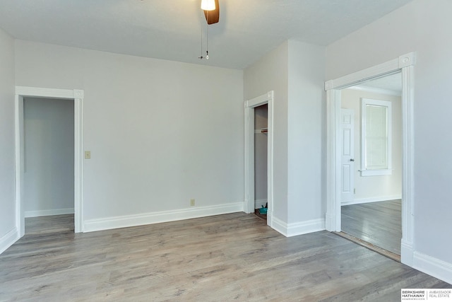 empty room with light hardwood / wood-style floors and ceiling fan