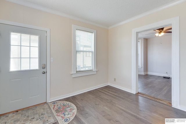 doorway to outside featuring wood-type flooring, ceiling fan, and crown molding