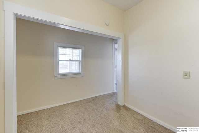 unfurnished room with light colored carpet