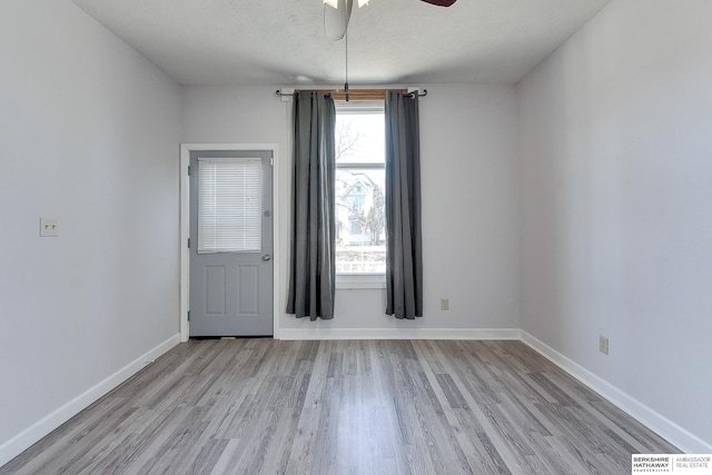 unfurnished room featuring ceiling fan, a textured ceiling, and light hardwood / wood-style flooring