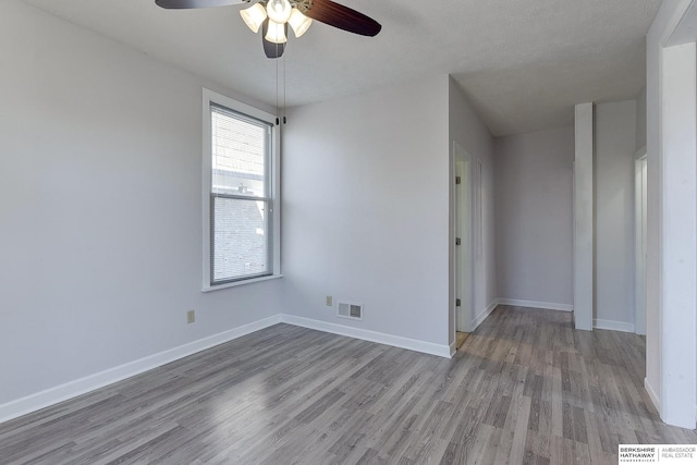 spare room with light hardwood / wood-style floors and ceiling fan