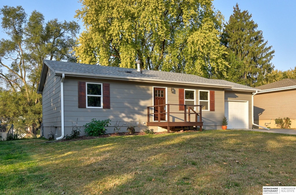 ranch-style home with a front yard and a garage