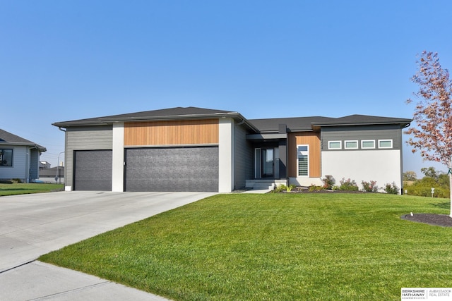 view of front of home with a garage and a front lawn