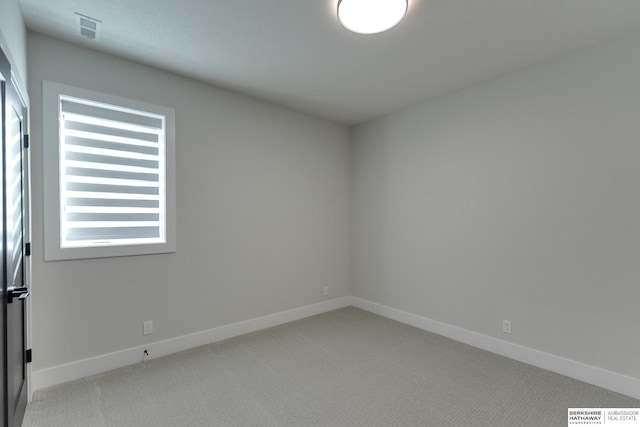 empty room featuring light colored carpet