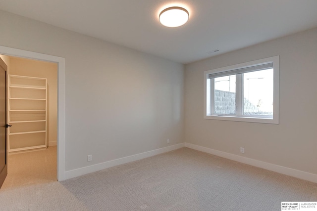 empty room featuring light colored carpet