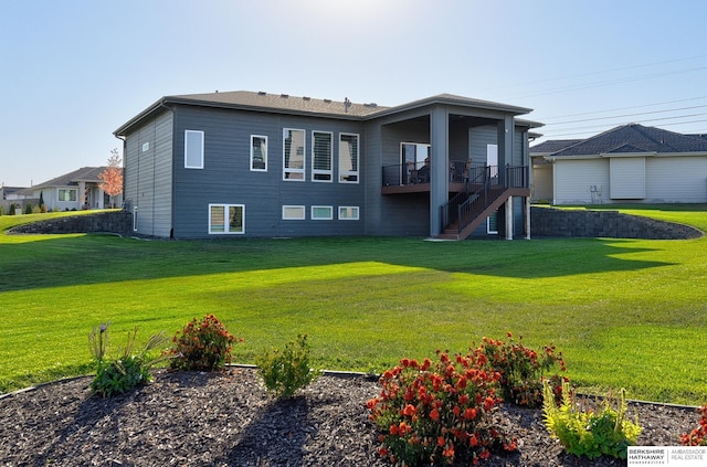 rear view of house featuring a yard and a deck