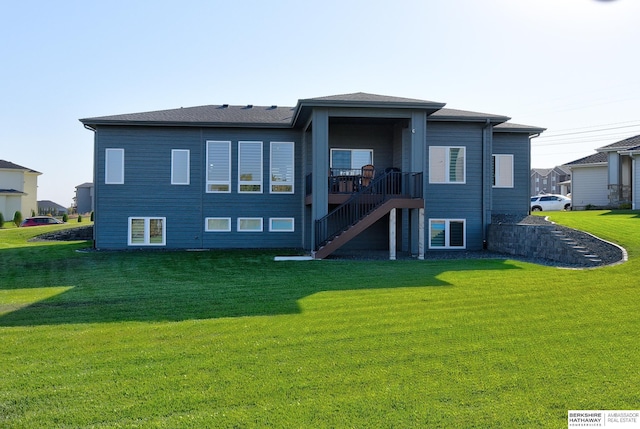 back of property featuring a deck and a lawn