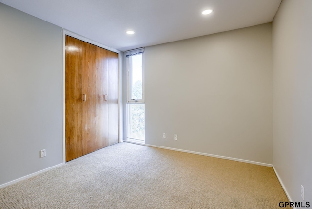 empty room with light colored carpet