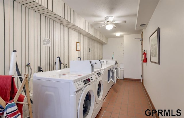 laundry area featuring tile patterned floors, ceiling fan, and washer and clothes dryer