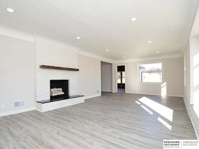 unfurnished living room featuring a fireplace and light wood-type flooring