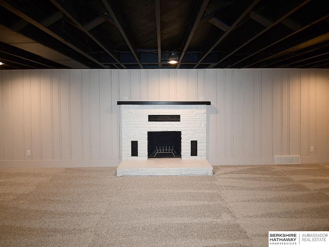 basement featuring a fireplace and carpet floors