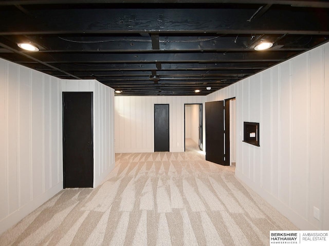 basement featuring light colored carpet