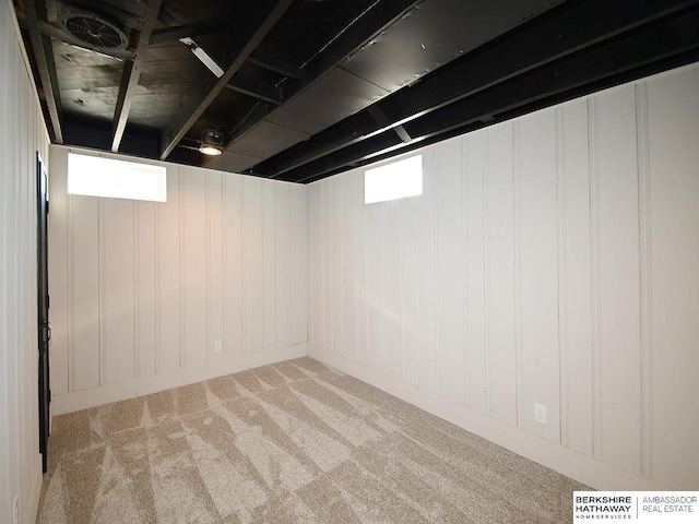 basement with light carpet and plenty of natural light