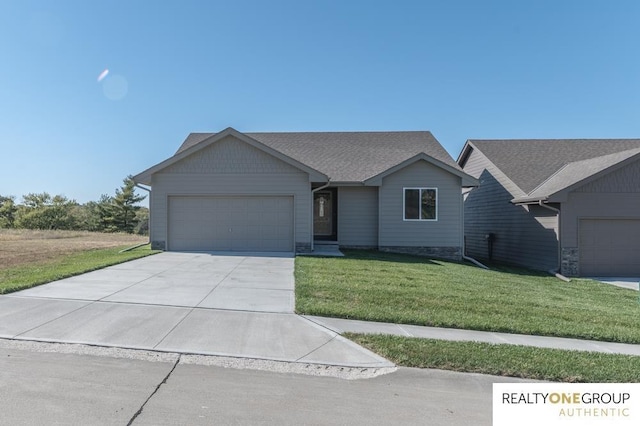 single story home featuring a garage and a front lawn