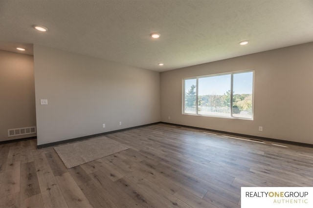 spare room with light wood-type flooring