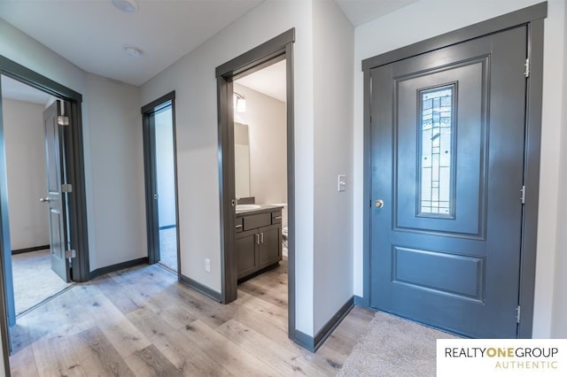 entrance foyer featuring sink and light hardwood / wood-style flooring