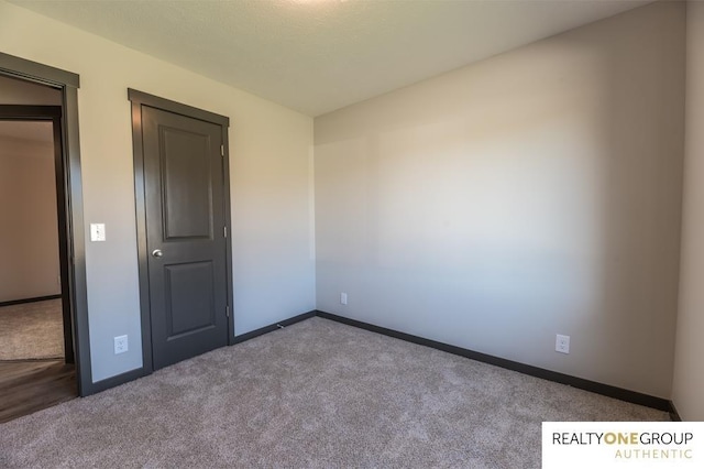 unfurnished room featuring light carpet