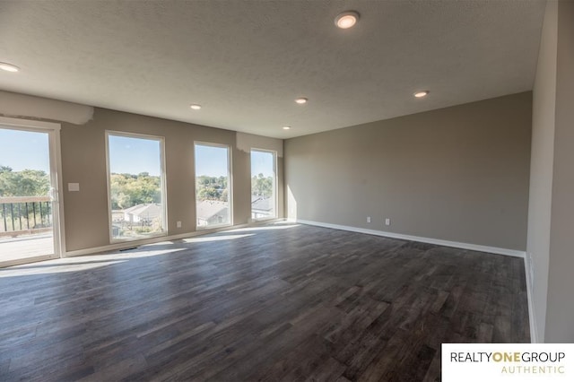 unfurnished room with dark wood-type flooring