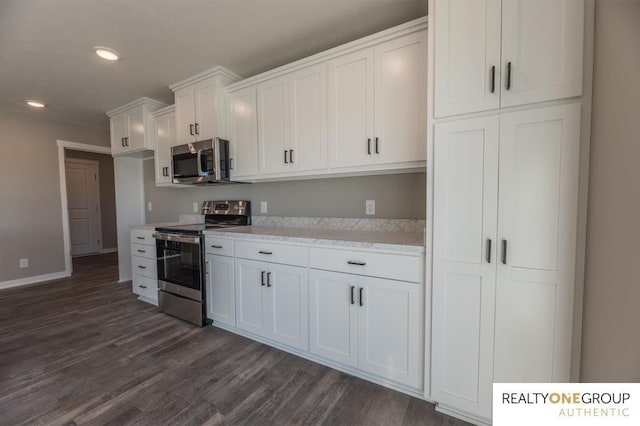 kitchen with white cabinetry, dark hardwood / wood-style flooring, and stainless steel appliances