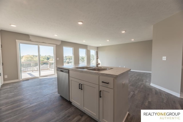 kitchen with a kitchen island with sink, stainless steel dishwasher, dark hardwood / wood-style floors, a textured ceiling, and white cabinetry