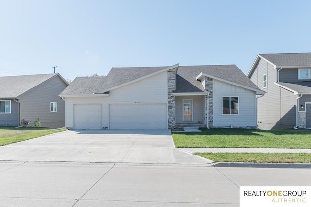 view of front of property with a front yard and a garage