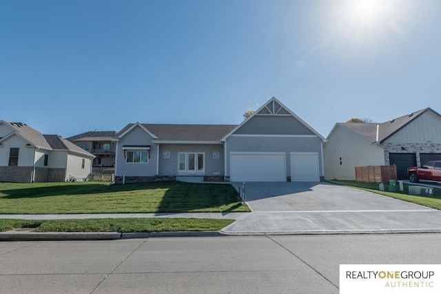 view of front of home with a front lawn and a garage