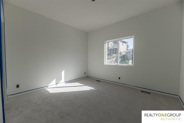 spare room featuring light colored carpet