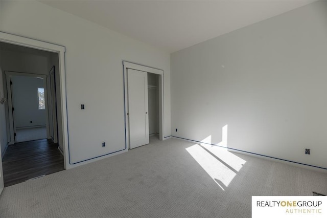 unfurnished bedroom featuring carpet flooring and a closet