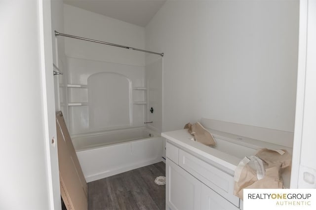 bathroom with hardwood / wood-style flooring and bathtub / shower combination