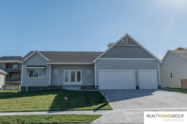 view of front facade with french doors, a garage, and a front lawn