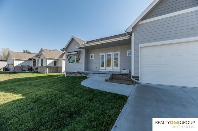 view of front of property with a garage and a front lawn