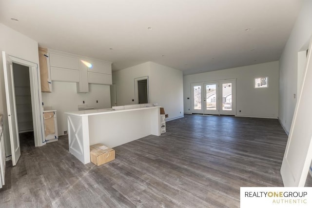 kitchen featuring dark hardwood / wood-style floors, white cabinetry, and a kitchen island