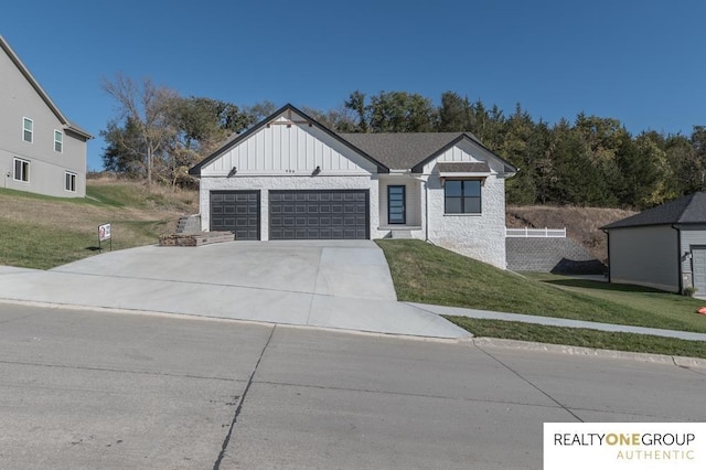 view of front of property featuring a garage and a front lawn