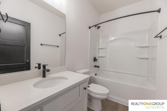 full bathroom featuring vanity, toilet, wood-type flooring, and bathing tub / shower combination