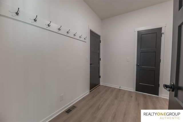 mudroom with light hardwood / wood-style floors